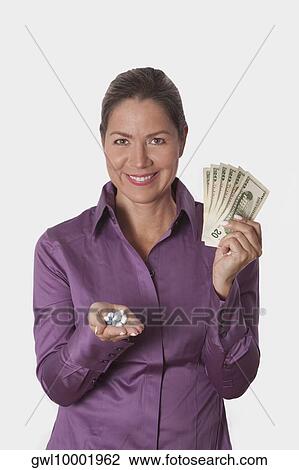 Woman holding pills and currency notes View Large Photo Image Stock Image - Woman holding pills and currency notes. Fotosearch