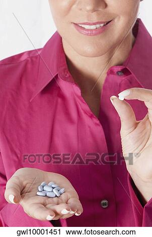 Woman holding pills View Large Photo Image Stock Image - Woman holding pills. Fotosearch