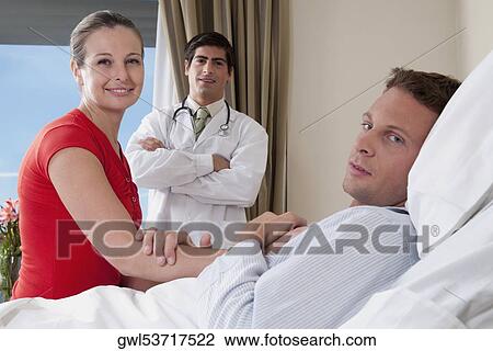 Woman in a hospital with her husband View Large Photo Image Stock Image - Woman in a hospital with her husband. Fotosearch