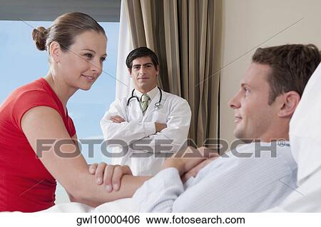 Woman in a hospital with her husband View Large Photo Image Stock Photograph - Woman in a hospital with her husband. Fotosearch