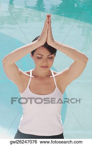 Woman in prayer position at the poolside View Large Photo Image Stock Photograph - Woman in prayer position at the poolside. Fotosearch