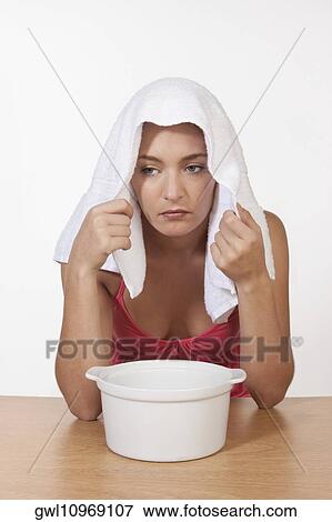 Woman inhaling steam View Large Photo Image Stock Photo - Woman inhaling steam. Fotosearch