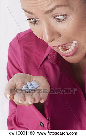 Woman looking at pills and shouting View Large Photo Image Stock Image - Woman looking at pills and shouting. Fotosearch