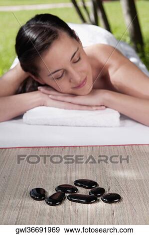 Woman lying on a massage table View Large Photo Image Stock Photo - Woman lying on a massage table. Fotosearch