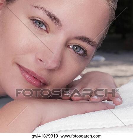 Woman lying on a massage table View Large Photo Image Stock Photo - Woman lying on a massage table. Fotosearch