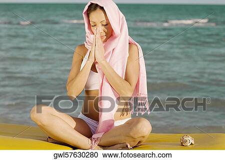 Woman meditating at the seaside View Large Photo Image Stock Image - Woman meditating at the seaside. Fotosearch