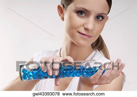 Woman pouring bath beads on her palm View Large Photo Image Stock Photo - Woman pouring bath beads on her palm. Fotosearch