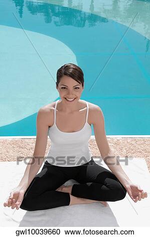 Woman practicing yoga at the poolside View Large Photo Image Stock Image - Woman practicing yoga at the poolside. Fotosearch