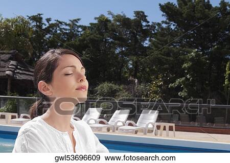 Woman practicing yoga at the poolside View Large Photo Image Stock Photo - Woman practicing yoga at the poolside. Fotosearch