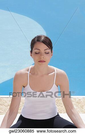 Woman practicing yoga at the poolside View Large Photo Image Stock Photography - Woman practicing yoga at the poolside. Fotosearch