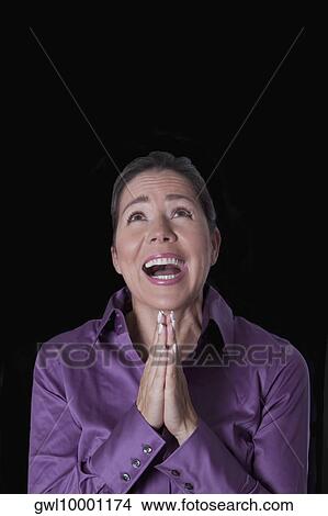Picture - Woman praying. Fotosearch