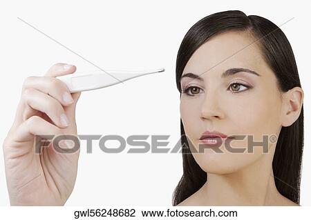 Woman reading a thermometer View Large Photo Image Stock Image - Woman reading a thermometer. Fotosearch