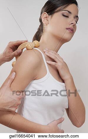 Stock Image - Woman receiving a shoulder massage. Fotosearch