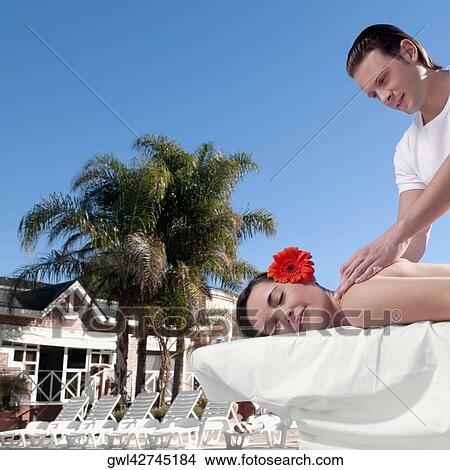Woman receiving back massage from a massage therapist View Large Photo Image Picture - Woman receiving back massage from a massage therapist. Fotosearch