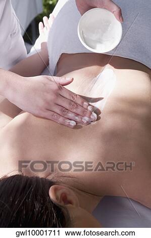 Woman receiving back massage from a massage therapist View Large Photo Image Stock Image - Woman receiving back massage from a massage therapist. Fotosearch
