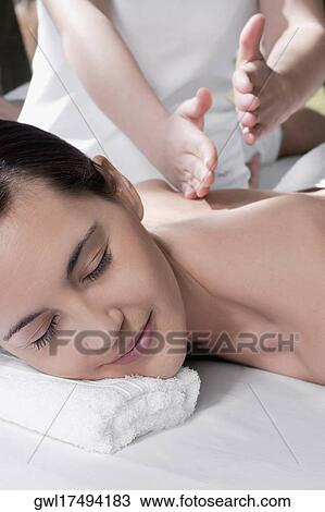 Woman receiving back massage from a massage therapist View Large Photo Image Stock Image - Woman receiving back massage from a massage therapist. Fotosearch