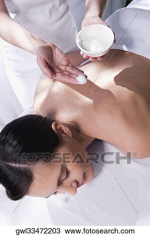 Woman receiving back massage from a massage therapist View Large Photo Image Stock Image - Woman receiving back massage from a massage therapist. Fotosearch