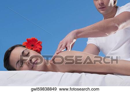 Woman receiving back massage from a massage therapist View Large Photo Image Stock Photo - Woman receiving back massage from a massage therapist. Fotosearch