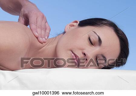 Woman receiving back massage from a massage therapist View Large Photo Image Stock Photograph - Woman receiving back massage from a massage therapist. Fotosearch