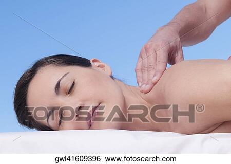 Woman receiving back massage from a massage therapist View Large Photo Image Stock Photograph - Woman receiving back massage from a massage therapist. Fotosearch