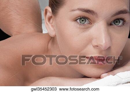 Stock Image - Woman receiving back massage. Fotosearch