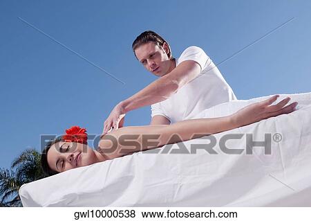 Woman receiving back massage View Large Photo Image Stock Photo - Woman receiving back massage. Fotosearch