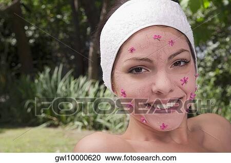 Stock Image - Woman receiving facial treatment. Fotosearch