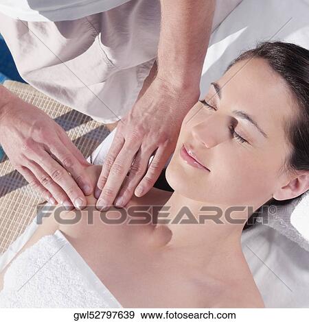 Woman receiving massage from a massage therapist View Large Photo Image Stock Photo - Woman receiving massage from a massage therapist. Fotosearch