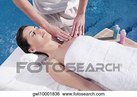 Woman receiving massage from a massage therapist View Large Photo Image Stock Photograph - Woman receiving massage from a massage therapist. Fotosearch