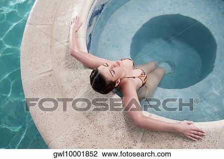 Woman relaxing in a hot tub View Large Photo Image Stock Image - Woman relaxing in a hot tub. Fotosearch