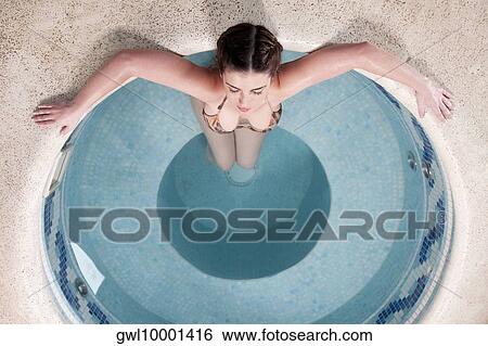 Woman relaxing in a hot tub View Large Photo Image Stock Photograph - Woman relaxing in a hot tub. Fotosearch