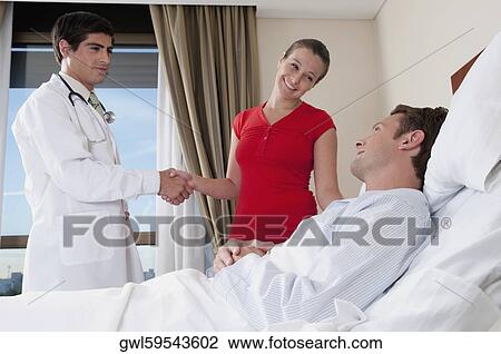 Woman shaking hand with a doctor View Large Photo Image Stock Image - Woman shaking hand with a doctor. Fotosearch
