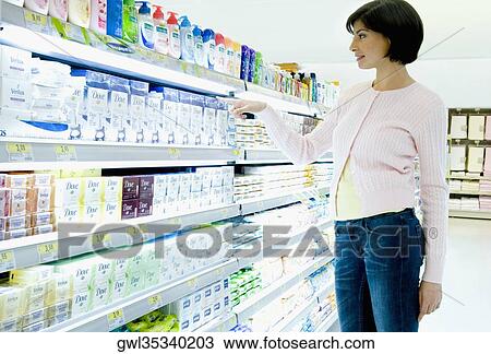 Stock Image - Woman shopping in a supermarket. Fotosearch