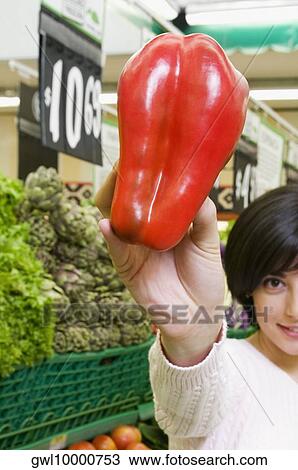 Woman shopping vegetables in a supermarket View Large Photo Image Stock Image - Woman shopping vegetables in a supermarket. Fotosearch