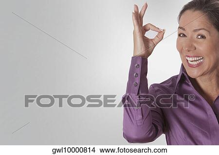 Woman showing OK sign View Large Photo Image Picture - Woman showing OK sign. Fotosearch