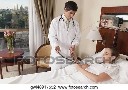 Woman signing on a clipboard View Large Photo Image Stock Image - Woman signing on a clipboard. Fotosearch