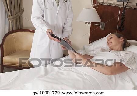 Stock Photo - Woman signing on a clipboard. Fotosearch