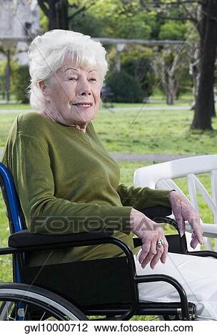 Woman sitting in a wheelchair View Large Photo Image Stock Image - Woman sitting in a wheelchair. Fotosearch