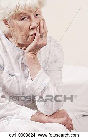 Woman sitting on the bed and thinking View Large Photo Image Picture - Woman sitting on the bed and thinking. Fotosearch