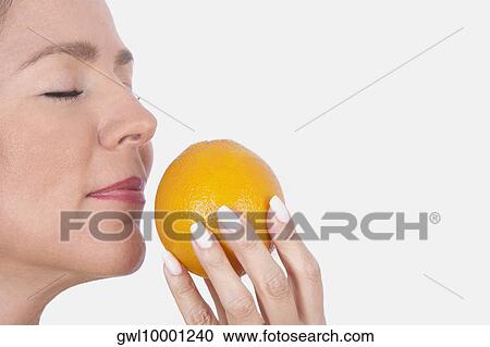 Woman smelling an orange View Large Photo Image Stock Image - Woman smelling an orange. Fotosearch