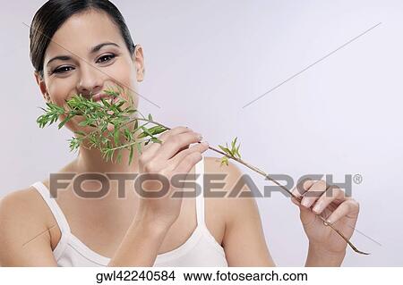 Picture - Woman smelling aroma herbs. Fotosearch