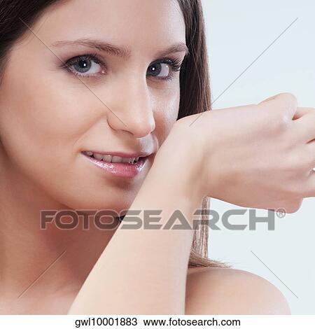 Woman smelling aromatherapy oil on her wrist View Large Photo Image Stock Image - Woman smelling aromatherapy oil on her wrist. Fotosearch