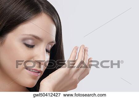 Woman smelling aromatherapy oil on her wrist View Large Photo Image Stock Photo - Woman smelling aromatherapy oil on her wrist. Fotosearch