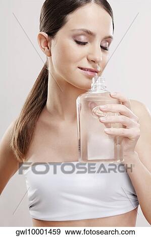 Woman smelling aromatherapy oil View Large Photo Image Stock Photo - Woman smelling aromatherapy oil. Fotosearch