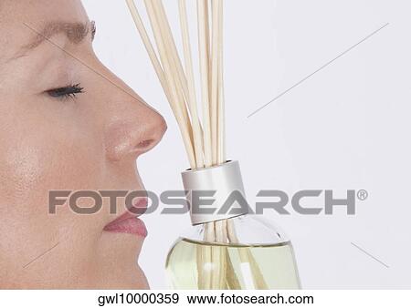 Woman smelling aromatherapy oil with incenses View Large Photo Image Stock Photo - Woman smelling aromatherapy oil with incenses. Fotosearch