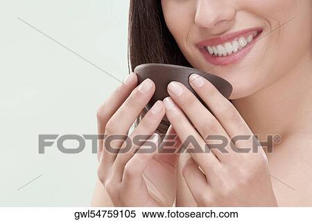 Woman smelling moisturizer cream View Large Photo Image Stock Photography - Woman smelling moisturizer cream. Fotosearch