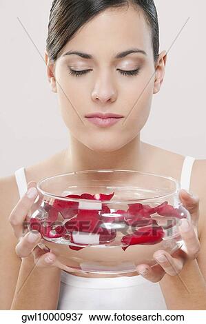 Woman smelling rose petals View Large Photo Image Stock Photo - Woman smelling rose petals. Fotosearch