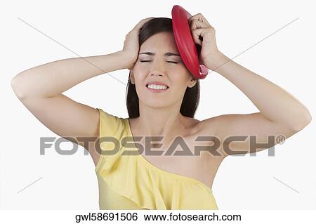 Woman suffering from a headache View Large Photo Image Stock Photograph - Woman suffering from a headache. Fotosearch