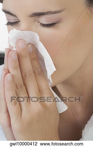 Stock Image - Woman suffering from cold. Fotosearch