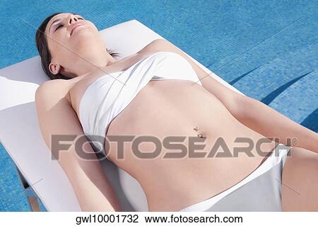 Woman sunbathing on a massage table View Large Photo Image Stock Image - Woman sunbathing on a massage table. Fotosearch